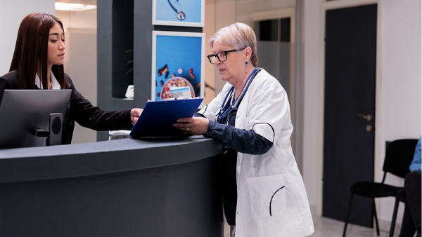 An international patient coordinator at a premier Turkish clinic meticulously planning a treatment schedule with a senior physician, ensuring a seamless and professionally managed healthcare journey.